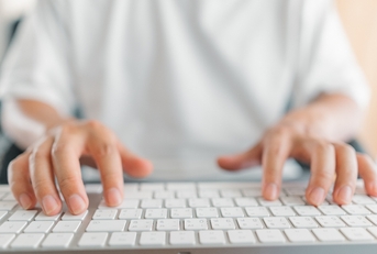 Close up of hands on keyboard