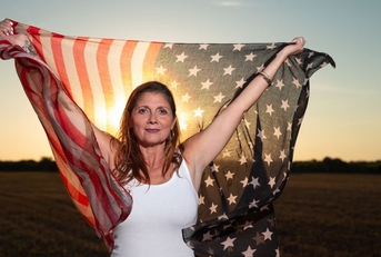 gen x woman holding an american flag