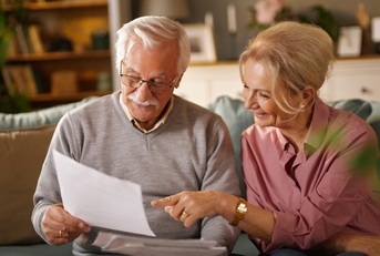 Happy older couple with paperwork
