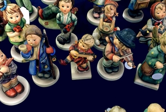 hummel porcelain figurines on a dark background