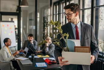 Man walking away fired from office job