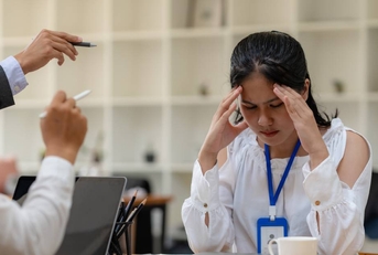 Female employee is scolded at office desk