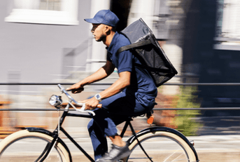 person working delivery gig on bike