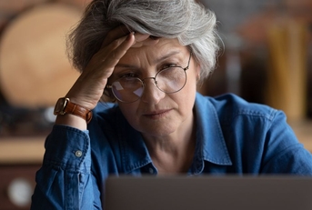 older woman frustrated on laptop