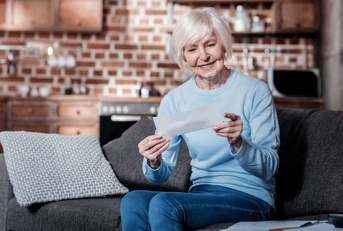 senior woman checking bill
