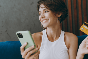 Smiling woman using credit card