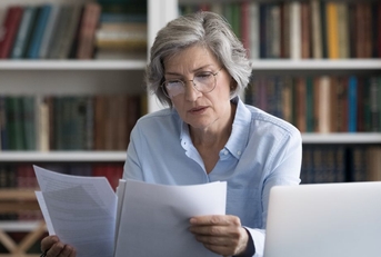older woman reviewing papers