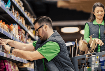 Grocery store workers stocking shelves