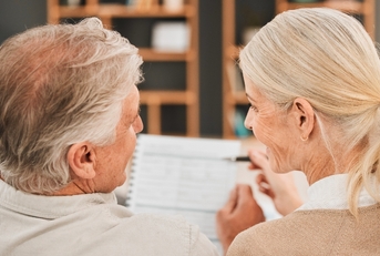 Older couple financial planning and looking at each other