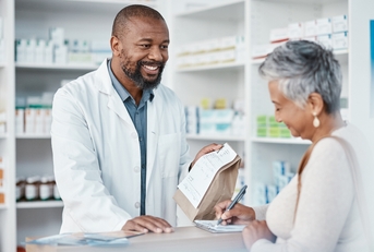 pharmacist and woman at counter 