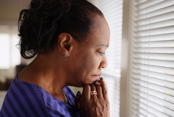 Woman in her 60s looking worried and thinking