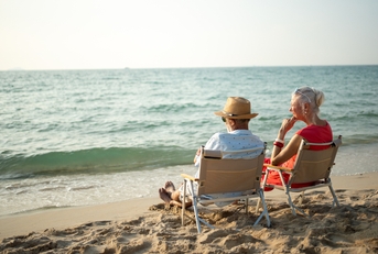 elderly sitting in chairs at the beach