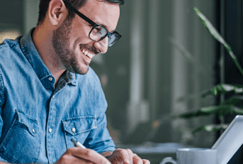person smiling at laptop