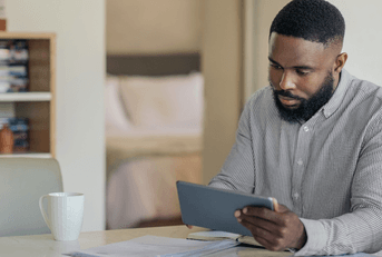 Man doing online banking on tablet