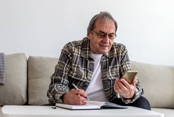 Senior man in living room for retirement research