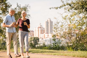 couple walking in summer city park