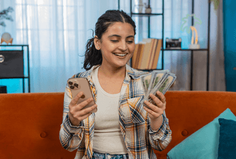 Girl with cell phone and cash