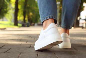 White shoes and jeans walking in the city
