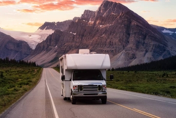 White RV Driving on scenic road