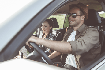 Couple driving in SUV