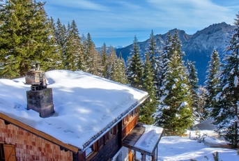 Winter mountain cabin in the snowy forest 