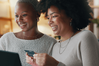 Friends shopping online with credit card