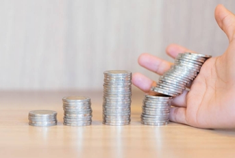 Stacked coins falling