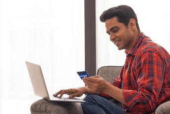 Man on laptop with credit card