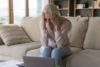 stressed older woman on couch