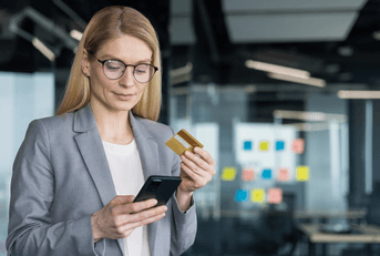 Woman with credit card on her phone