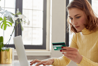Woman with credit card on laptop