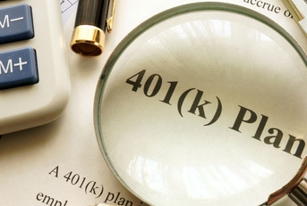 401(k) plan papers with magnifying glass