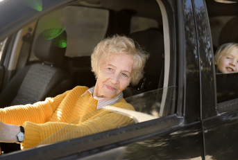 Grandma driving kid in car