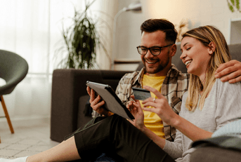 Couple using credit card on tablet