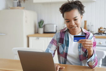 Woman on laptop with credit card