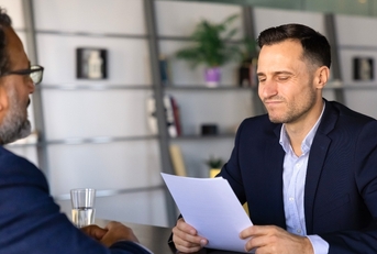 Young boss firing older employee