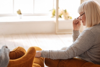 Widow looking at empty chair