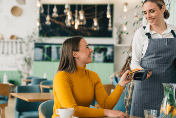 Woman using credit card at restaurant