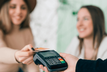 Woman using credit card to pay