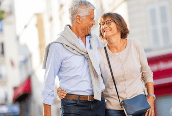 Older couple walking on street
