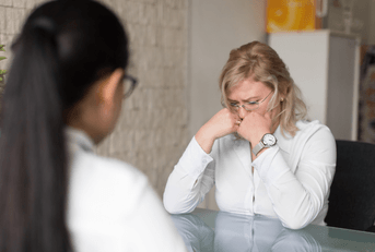 Employee sits in office getting fired
