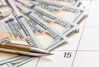 pen with money on a calendar