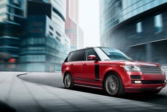 Red car fast drive on a road in a city at daytime 