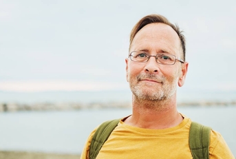 Middle aged man by the ocean