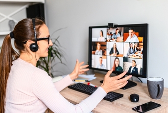 Woman working from home having a zoom meeting with several people