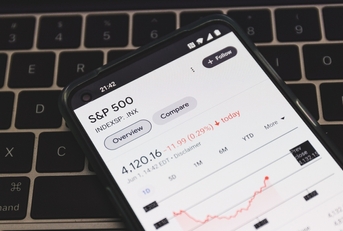 Phone with S&amp;P 500 Index on top of black keyboard