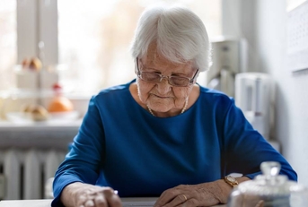 Senior woman filling out financial statements