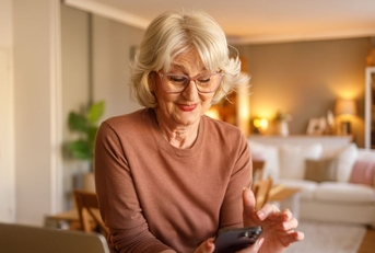 Retired woman smiling on cellphone