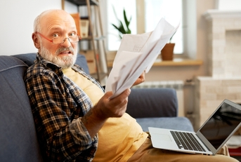 Senior with a lot of paperwork 