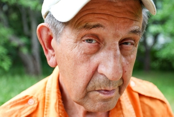 Sly older man looking at camera